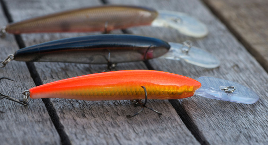 colorful fish baits are on a wooden background