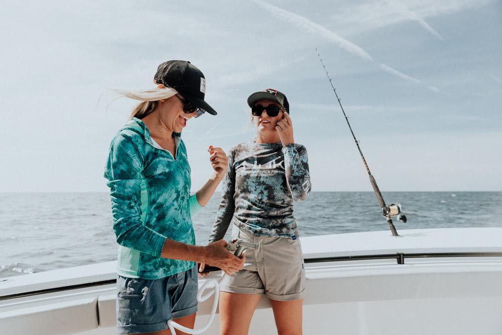 pair of women fishing on boat